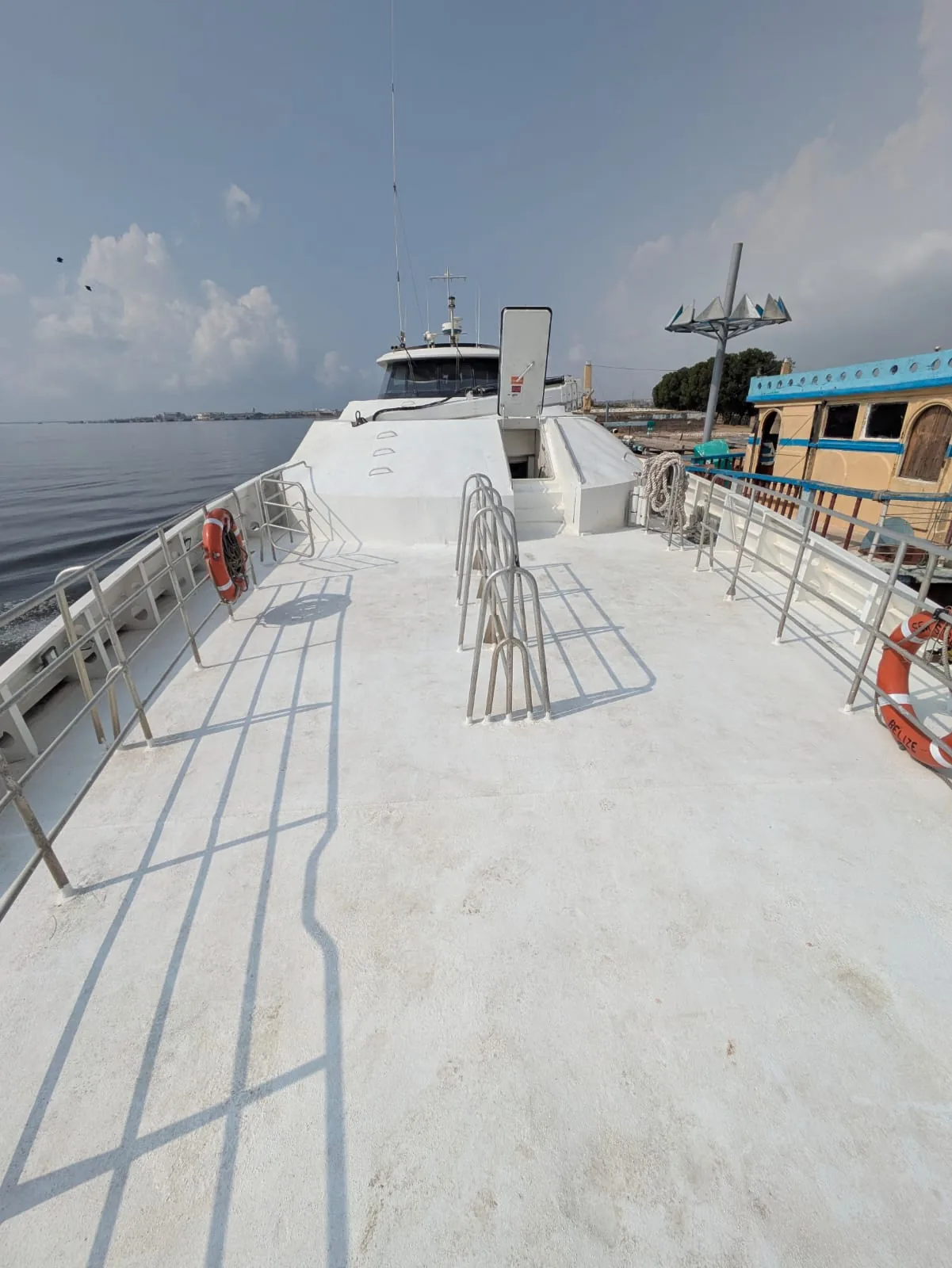 Commercial passenger boat for sale — side deck walkway with railings and lifebuoys
