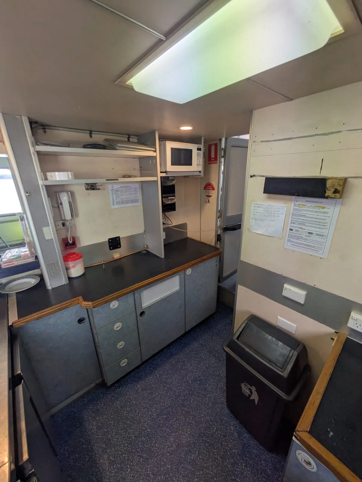 Passenger ferry for sale — galley and crew pantry with sink, storage and microwave